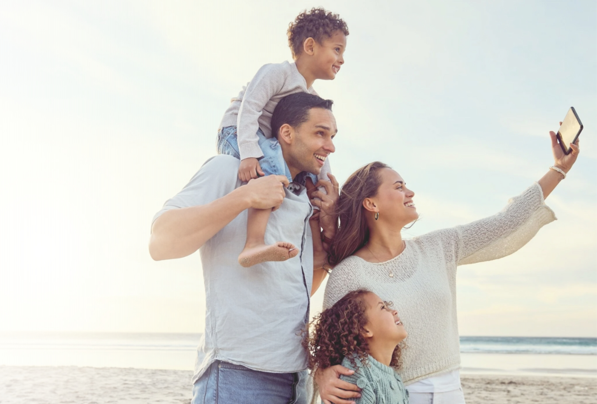family smiling at beach